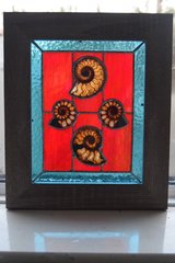 Stained glass panel with ammonites.